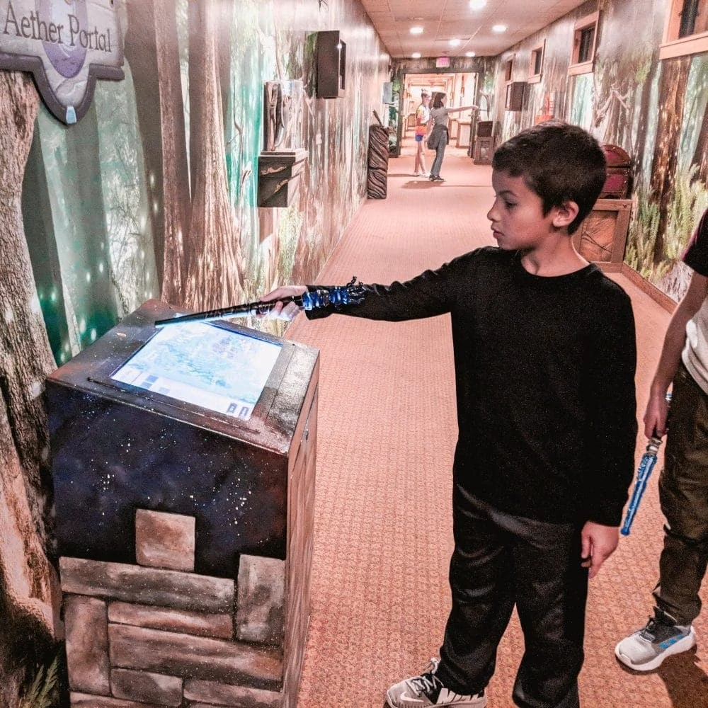 Boy playing MagiQuest at the Great Wolf Lodge