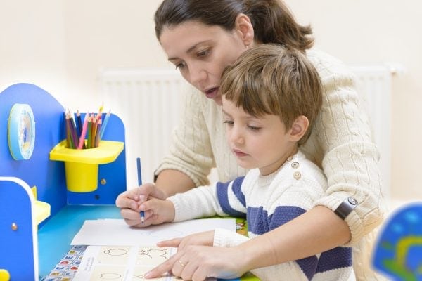 mom homeschooling her son