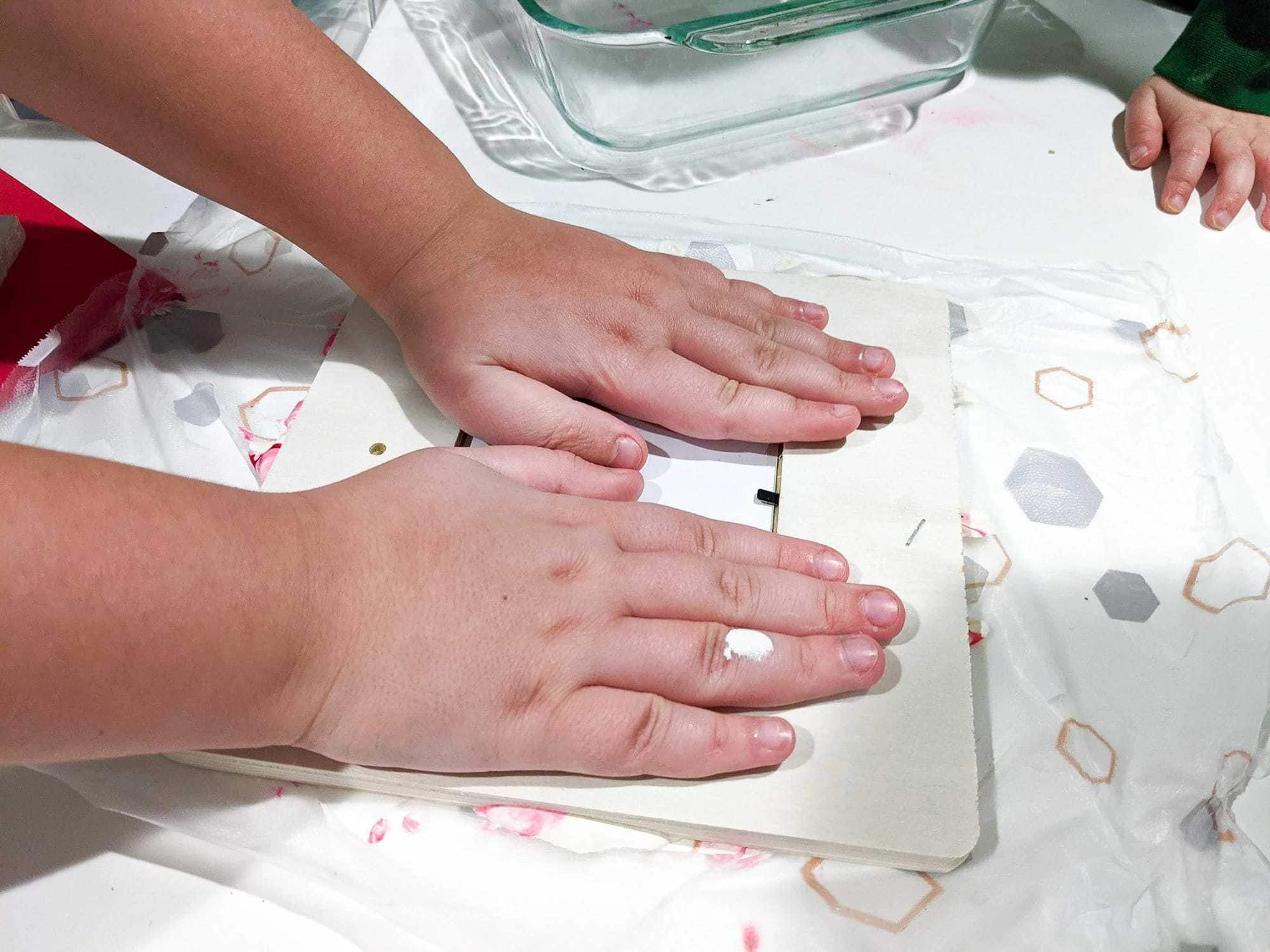 pressing unfinished photo frame into paint