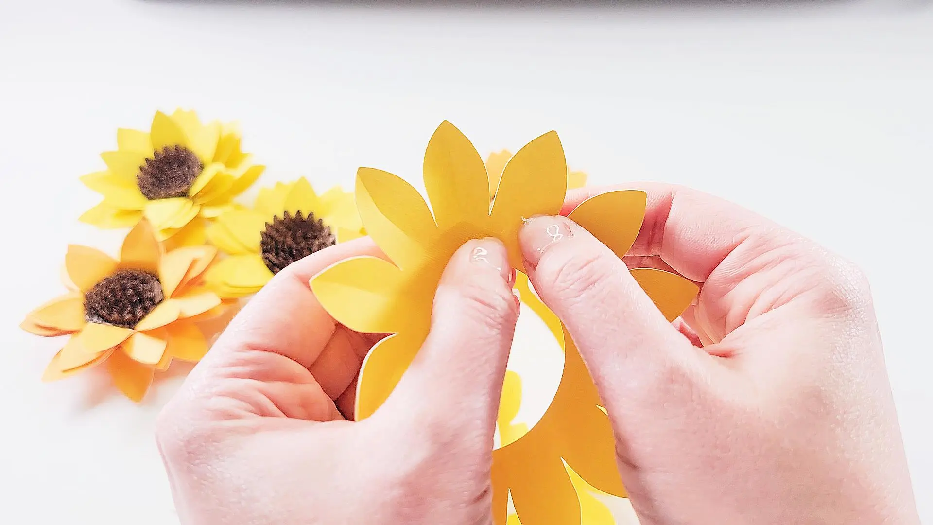 scoring the petals of a sunflower paper flower