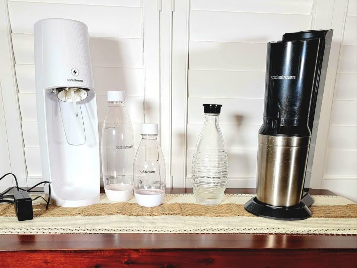 two soda stream machines sitting on the counter with plastic reusable bottles