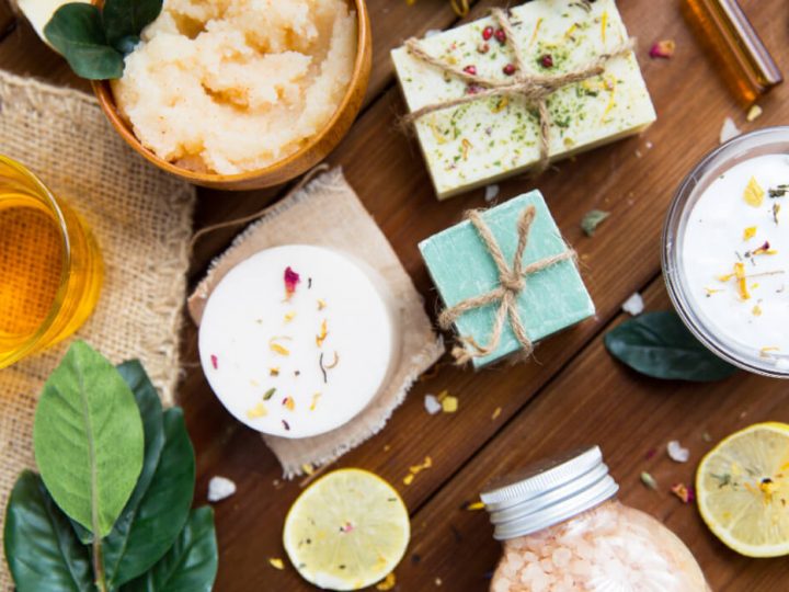 Natural skincare products, organic candles and herbs top view, flat lay.