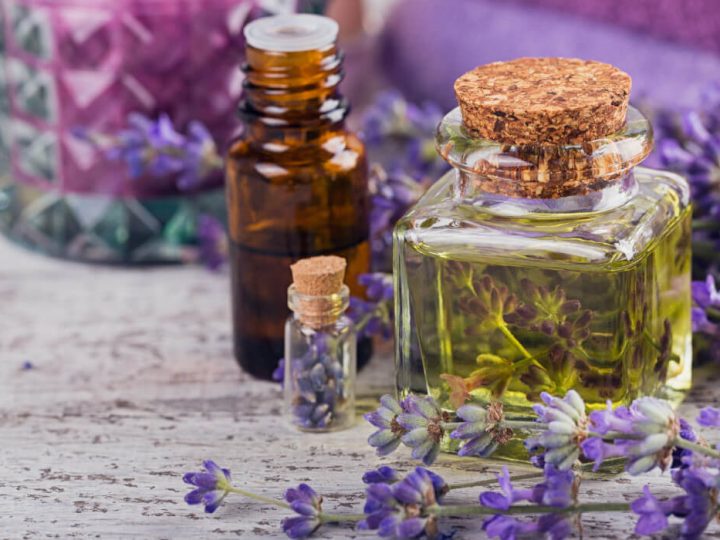 natural herbs and oils used for organic skincare sitting on the counter next to lavender flowers