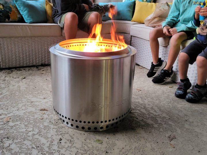 family sitting around the outdoor fire pit