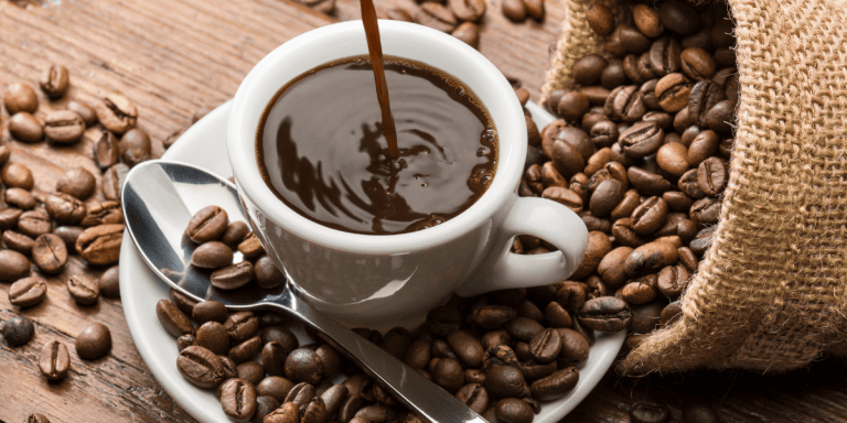 cup of coffee being poured into a coffee cup